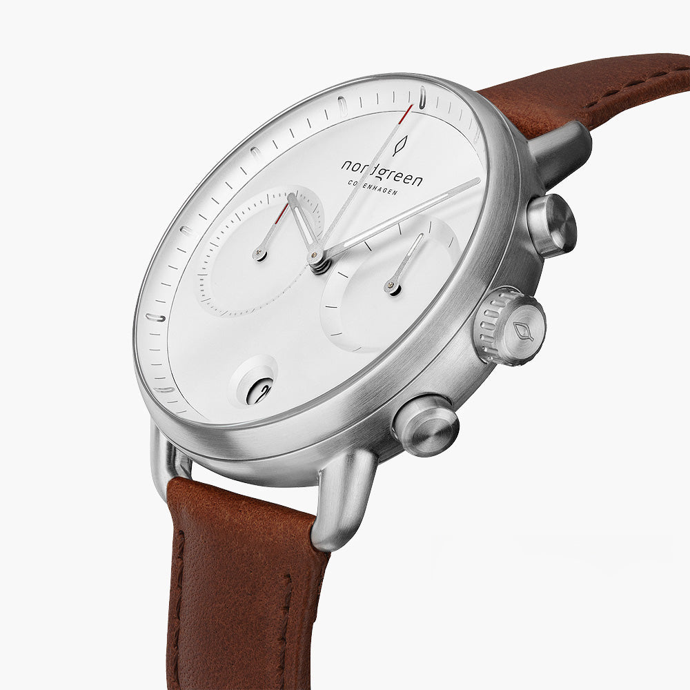 Angled view of the white dial, subdials and silver-tone pushers.