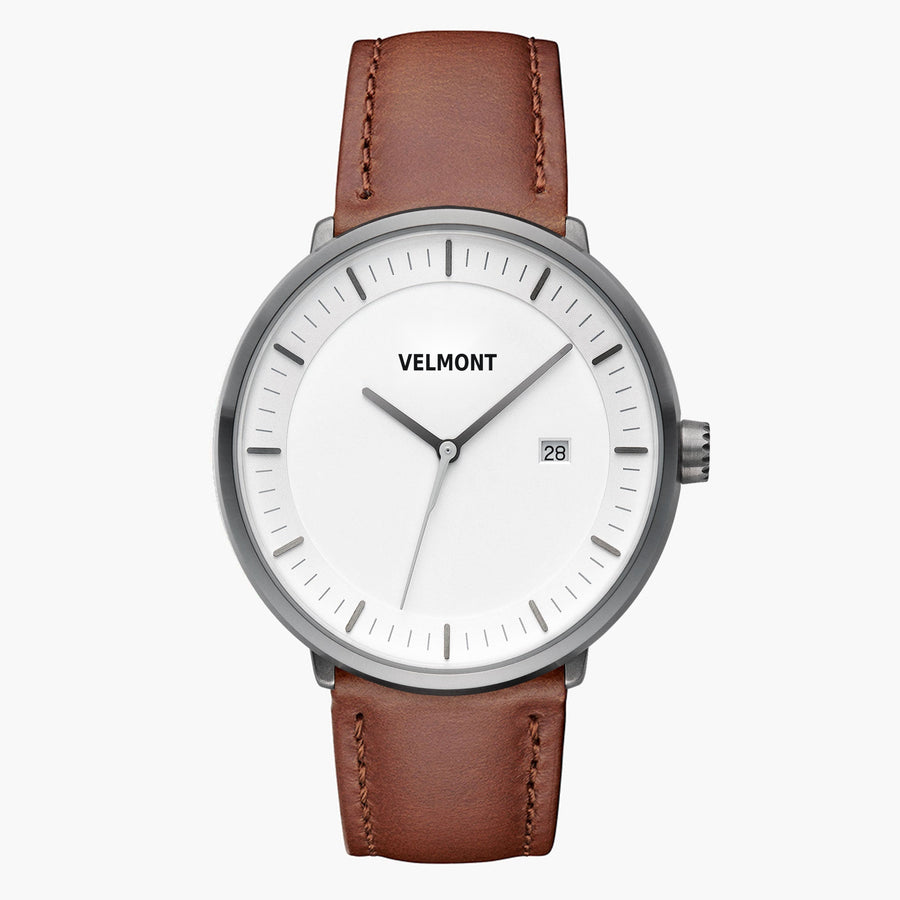 Front view of a gunmetal watch with a white dial on a brown strap.
