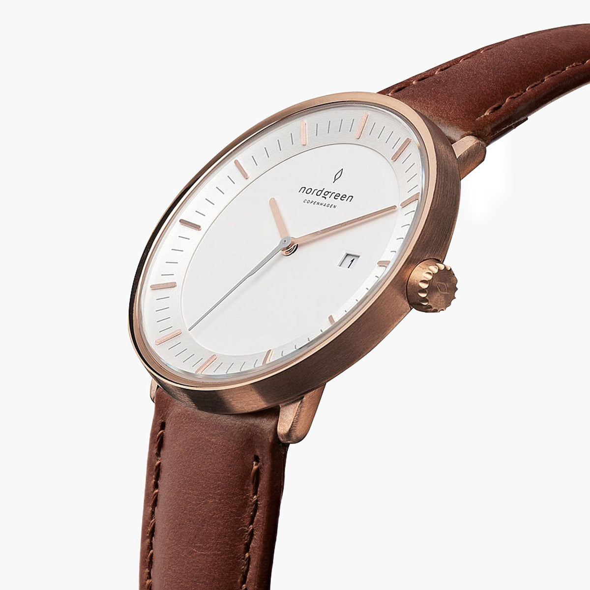 Three-quarter view of the watch showing the white dial and brown strap.