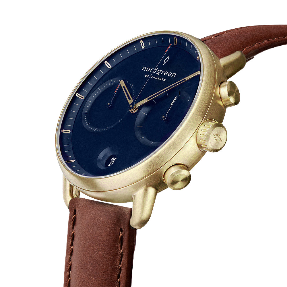 Angled view showing the two pushers and engraved crown on the gold-tone case.
