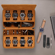 Top view of the open case filled with watches next to a spare strap
