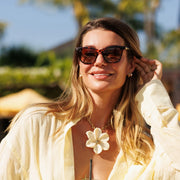 Woman adjusting cat eye sunglasses