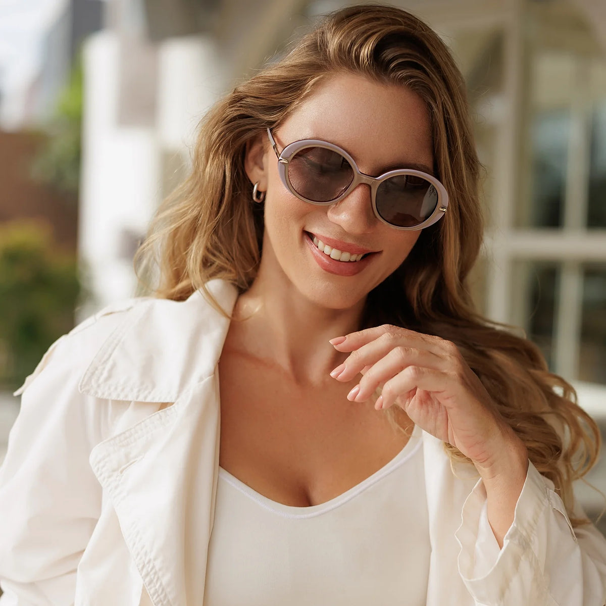 Woman smiling in lavender round sunglasses
