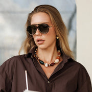 Woman in aviator sunglasses, side view