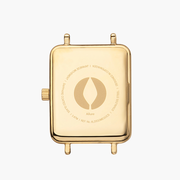 Back of the gold-tone rectangular case with an engraved emblem.