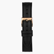 Smooth black watch strap paired with a rose gold-tone buckle and keepers.