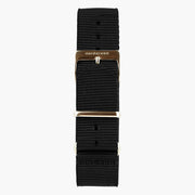 Black nylon strap with a warm rose gold-tone buckle, shown laid out vertically.