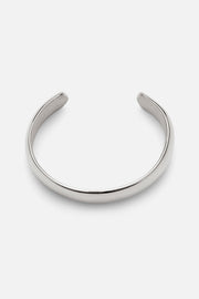 Silver-tone wide smooth cuff bracelet, front view on a light background
