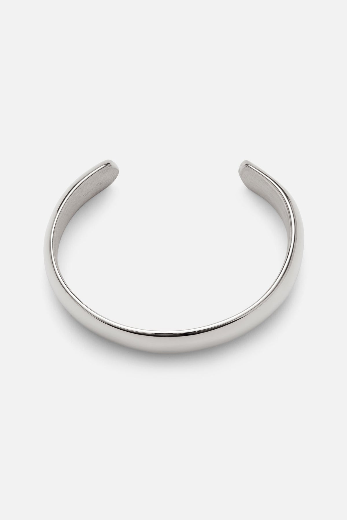 Silver-tone wide smooth cuff bracelet, front view on a light background