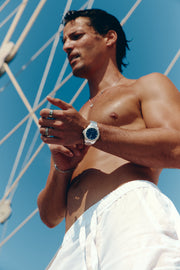 Man by the rigging of a sailboat wearing the watch