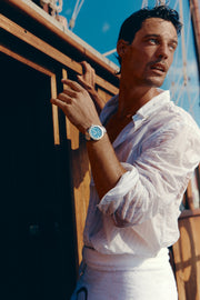 Man in a white shirt on a boat wearing the watch