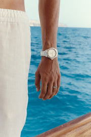 Close-up of the watch on the wrist, sea in the background