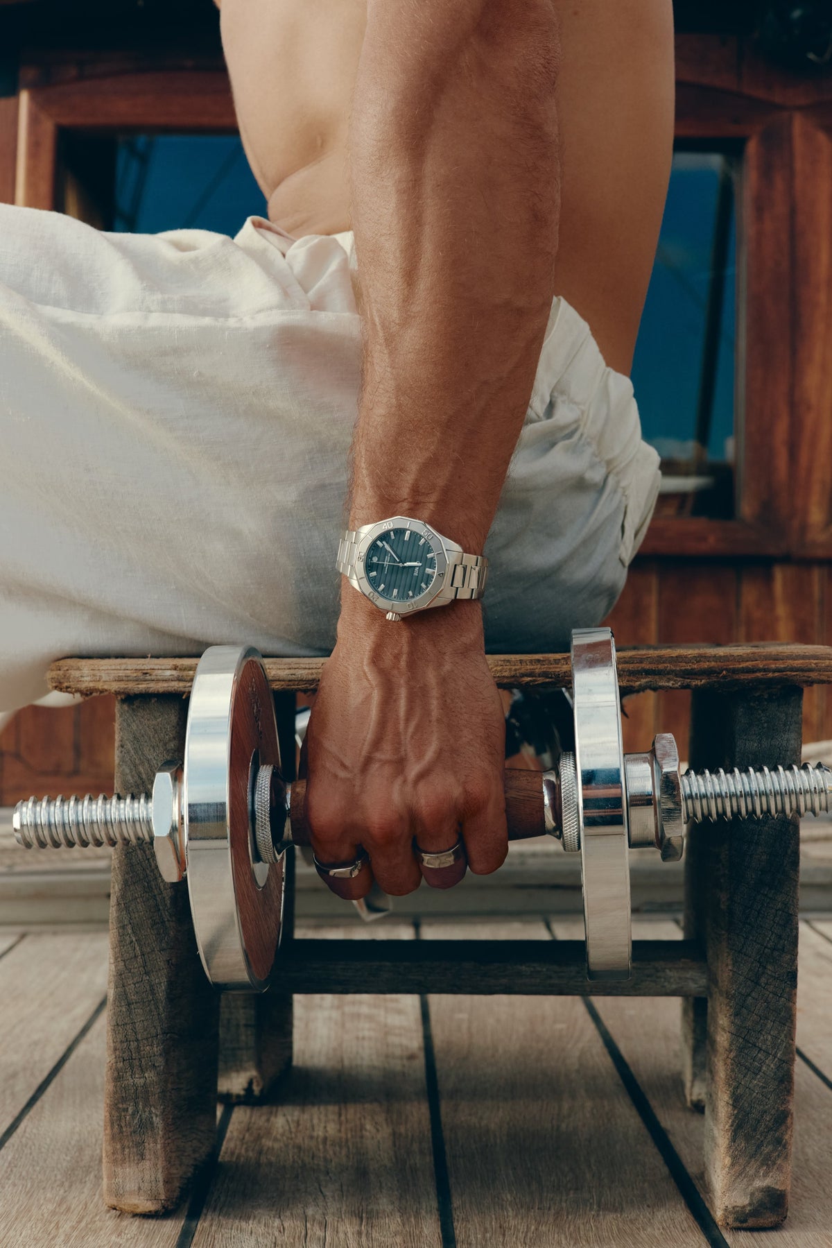 Wrist with the watch resting on a dumbbell bar