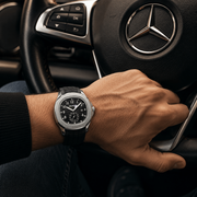 Silver-tone black-dial watch worn while driving