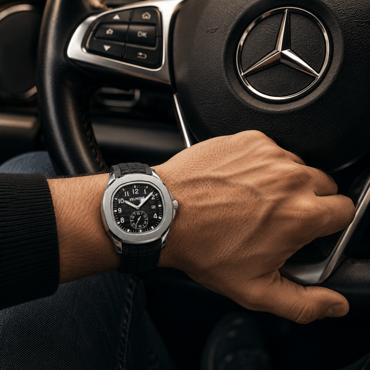 Silver-tone black-dial watch worn while driving