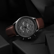 Gunmetal chronograph lying on a dark box
