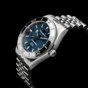 Blue dial watch on bracelet at an angle
