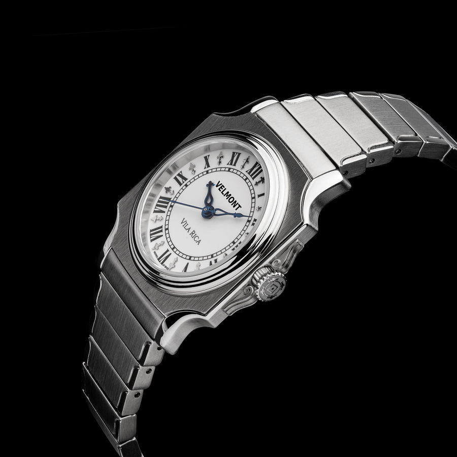 Small cushion-case watch at an angle on a black background