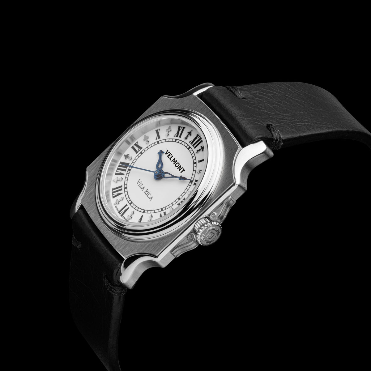 Small cushion-case watch at an angle on black