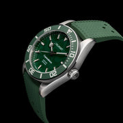 Green watch on green strap at an angle on black