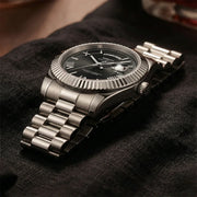Steel watch on dark fabric