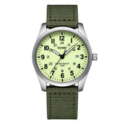 Steel field watch with pale dial on green fabric strap