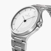 Angled view of the white dial, polished bezel and silver-tone crown.