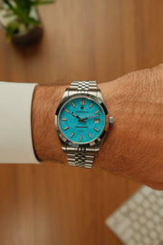 Turquoise watch on the wrist with a bracelet