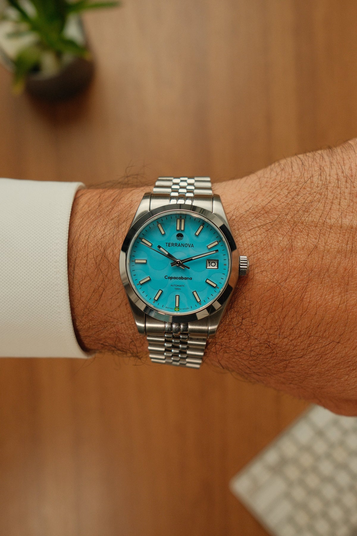 Turquoise watch on the wrist with a bracelet