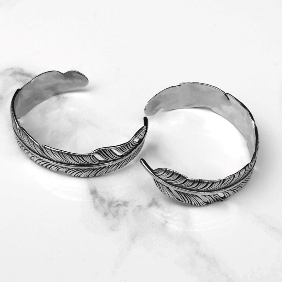 Two feather cuffs on white marble