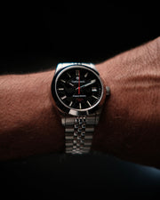 Black dial watch on the wrist
