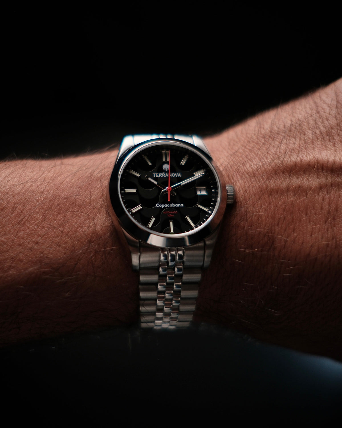Black dial watch on the wrist