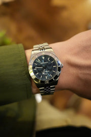 Blue dial watch on the wrist