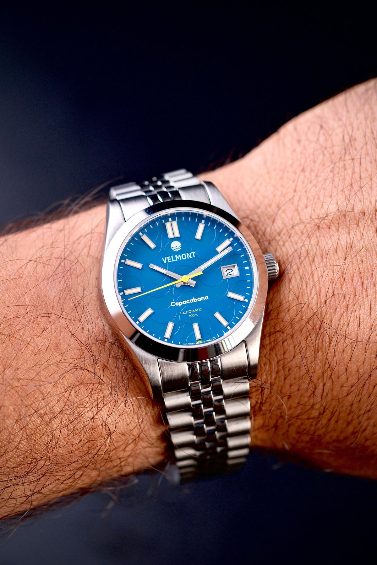 Blue dial watch on the wrist