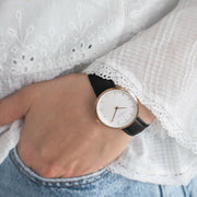 The watch worn with a white eyelet blouse and light blue jeans.