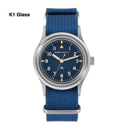 Blue-dial military watch on a blue strap labeled K1 Glass