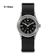 Black-dial military watch labeled K1 Glass