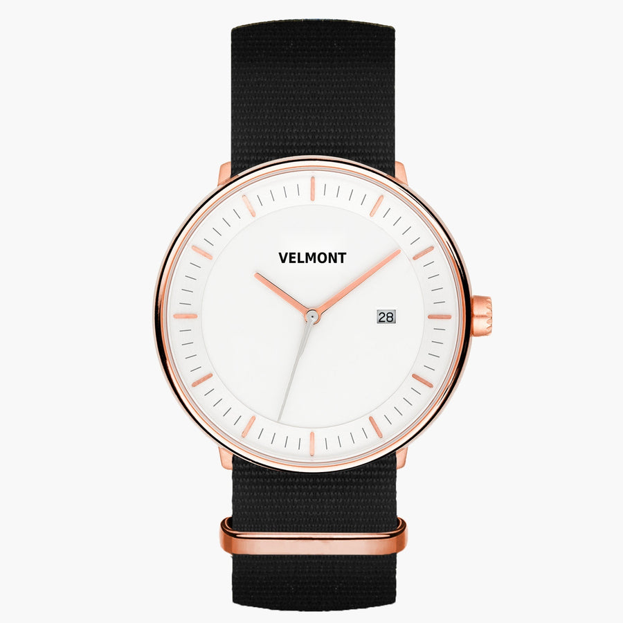 Watch with a white dial and rose gold-tone case on a black woven strap.
