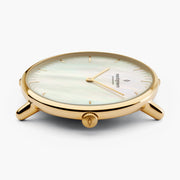 Profile of the slim gold-tone case showing the crown and thin lugs.