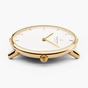 Low side angle of the gold-tone case with the white dial in view.