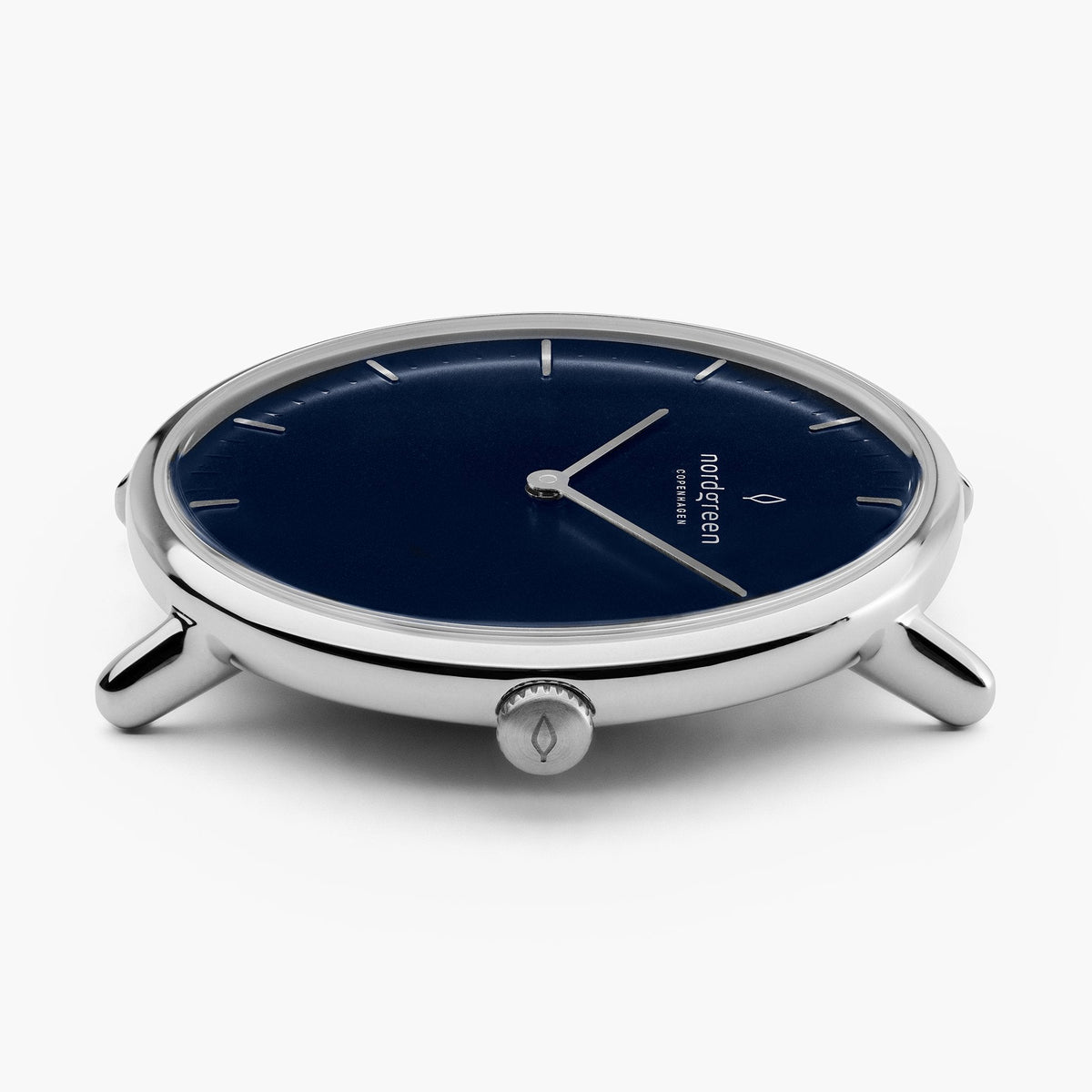 The thin silver-tone case from a low angle, slender lugs and crown visible.