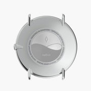 The silver-tone case back, shown on its own without the strap.