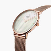 Angled close view of the rose gold-tone case and crown with the shimmering dial.