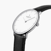 Three-quarter angle of the silver-tone case showing the crown and white dial.
