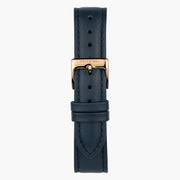 Navy strap with tonal stitching and a rose gold-tone buckle, laid out vertically.