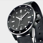 Angled view of the dotted bezel, knurled crown and wave-pattern dial.
