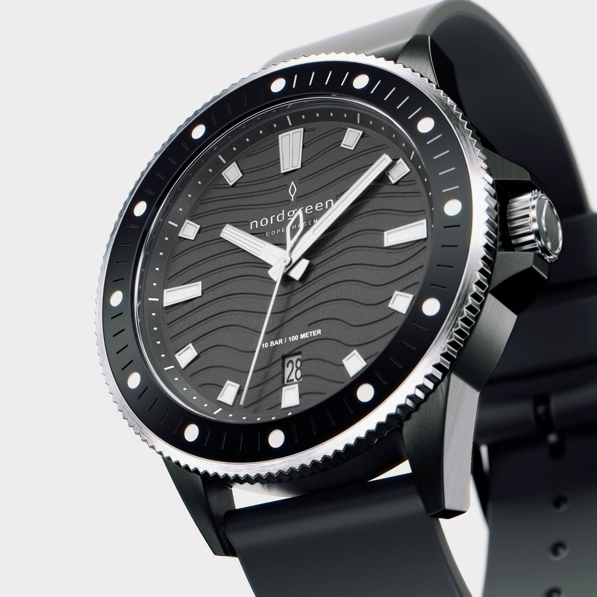 Angled view of the dark case, dotted bezel and silver-tone crown.