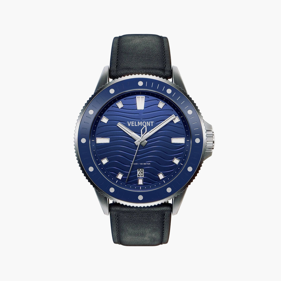 Diver-style watch with a blue wave-pattern dial and blue bezel on a black strap.