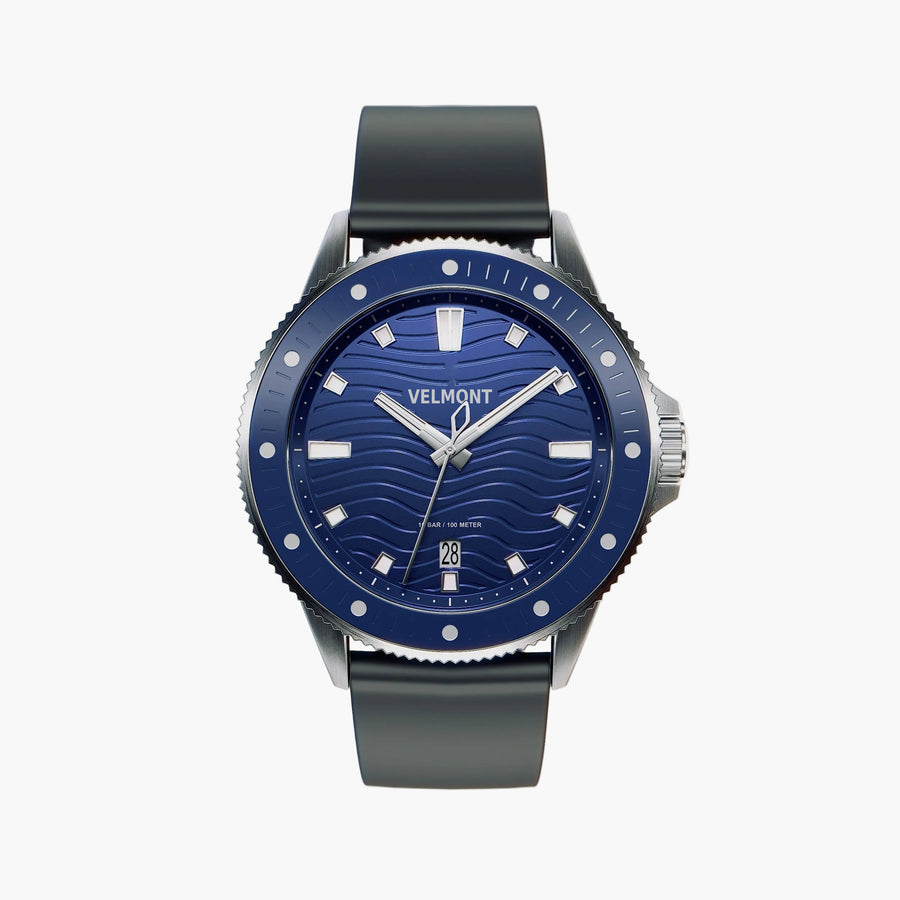 Diver-style watch with a blue wave-patterned dial, blue dotted bezel and dark strap.
