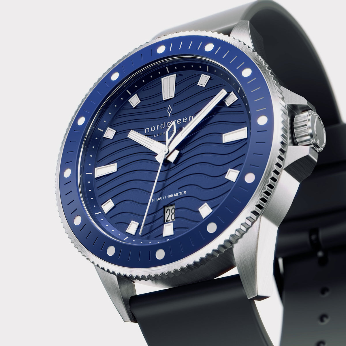 Angled view of the silver-tone case and crown with the blue bezel.